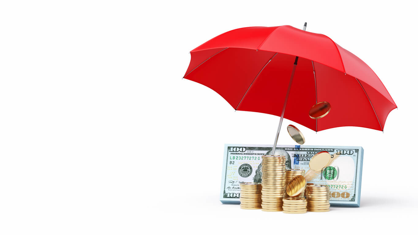 Stacks of gold coins and U.S. dollar bills protected by a red umbrella, symbolizing financial security and business coverage through commercial umbrella insurance.